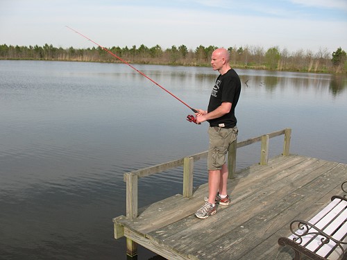 Dave fishing from a lake pier
