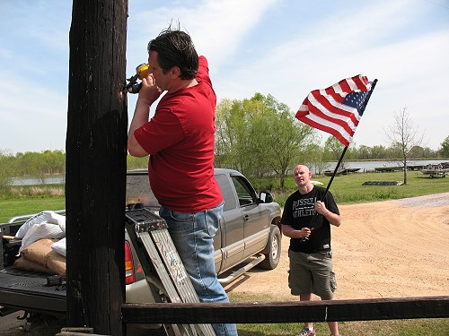 Jerry and Dave install an American flag at gate